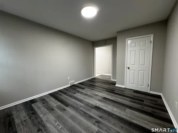 a view of a room with wooden floor and staircase