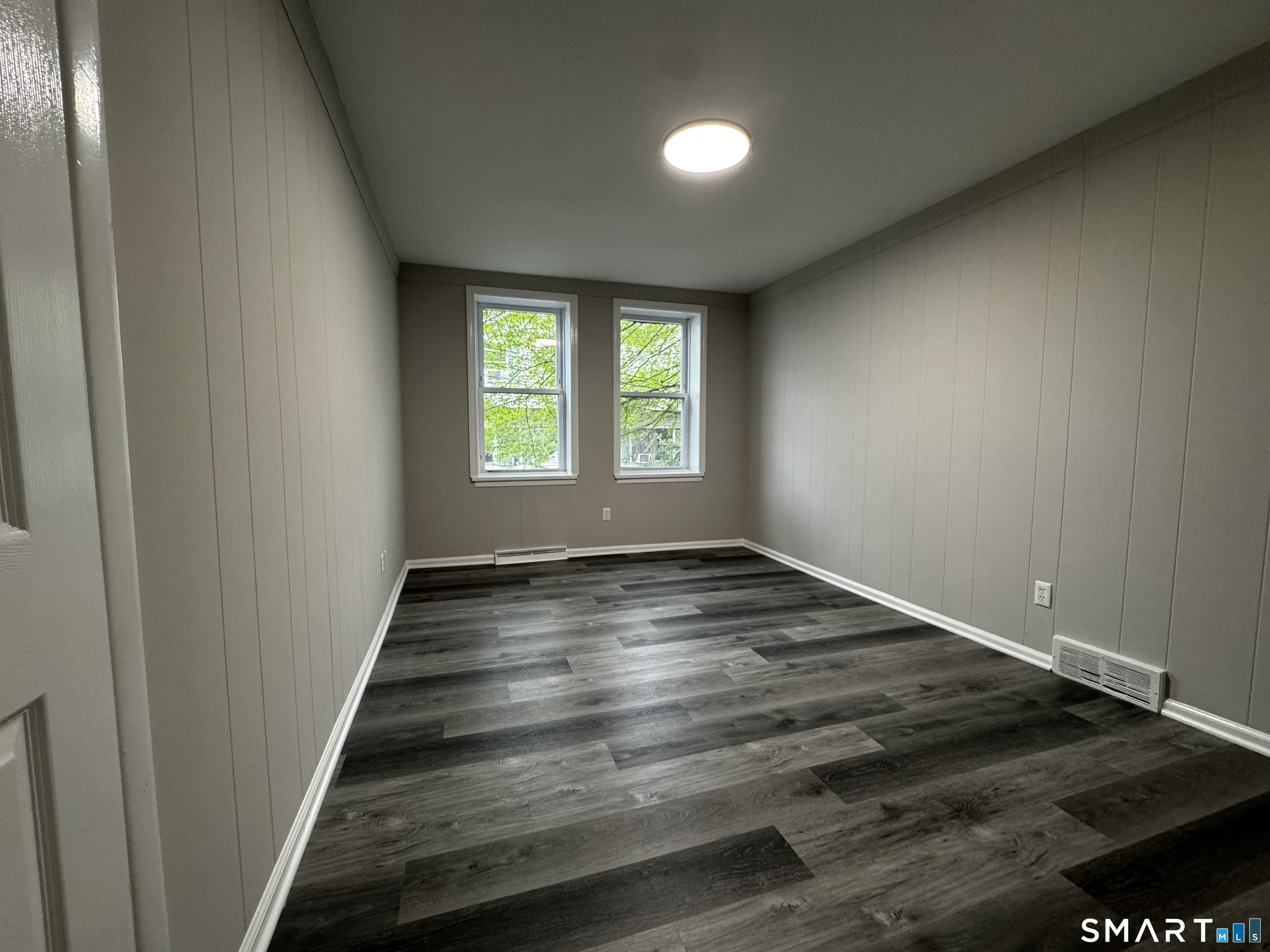 45-51 Cowles Street, Unit 45 Bridgeport, CT 06607 - Photo 20 of 33 an empty room with wooden floor and window
