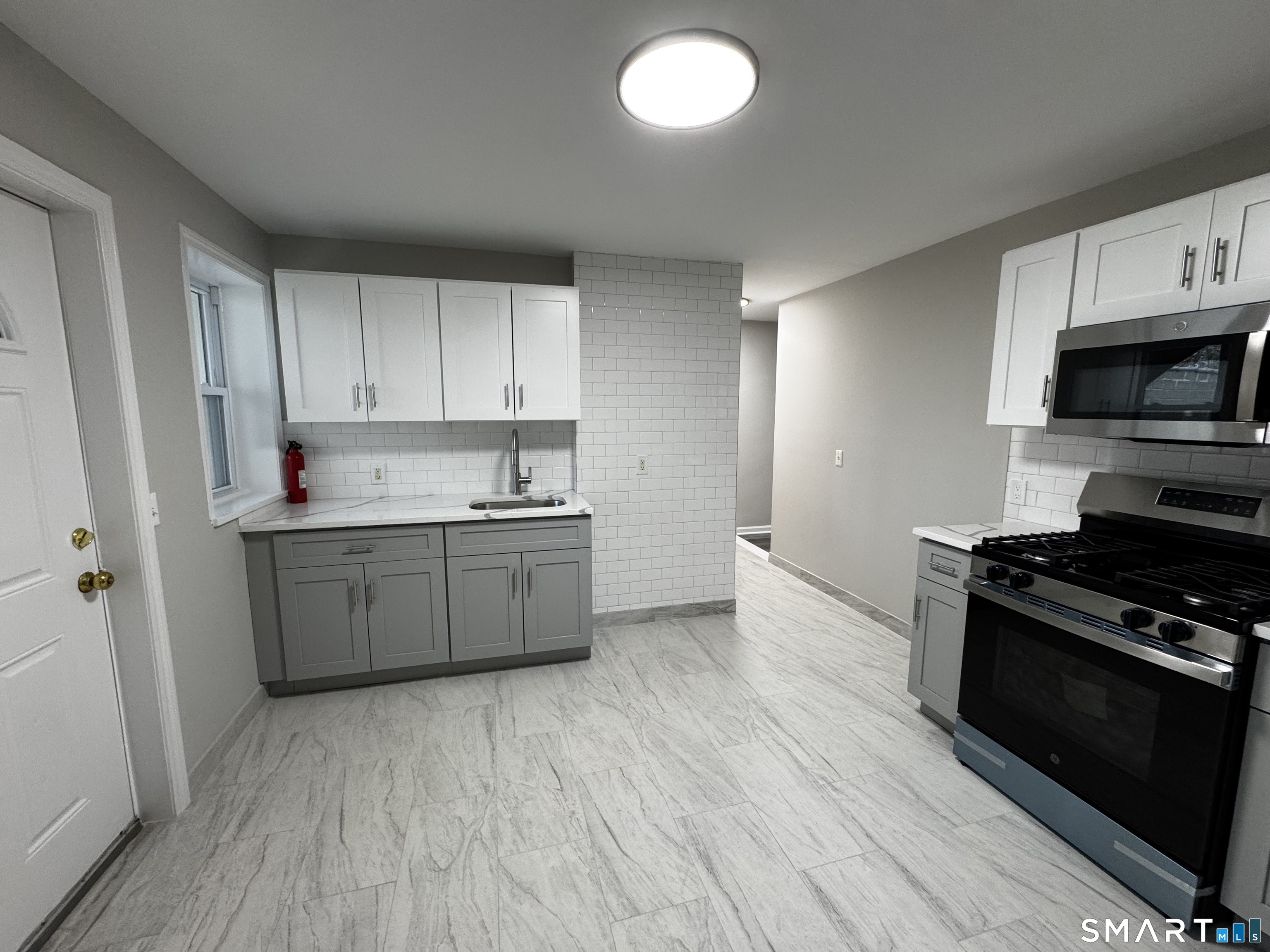 45-51 Cowles Street, Unit 45 Bridgeport, CT 06607 - Photo 2 of 33 a kitchen with granite countertop a sink cabinets and stainless steel appliances