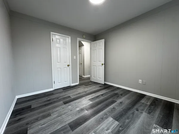 a view of an empty room and wooden floor