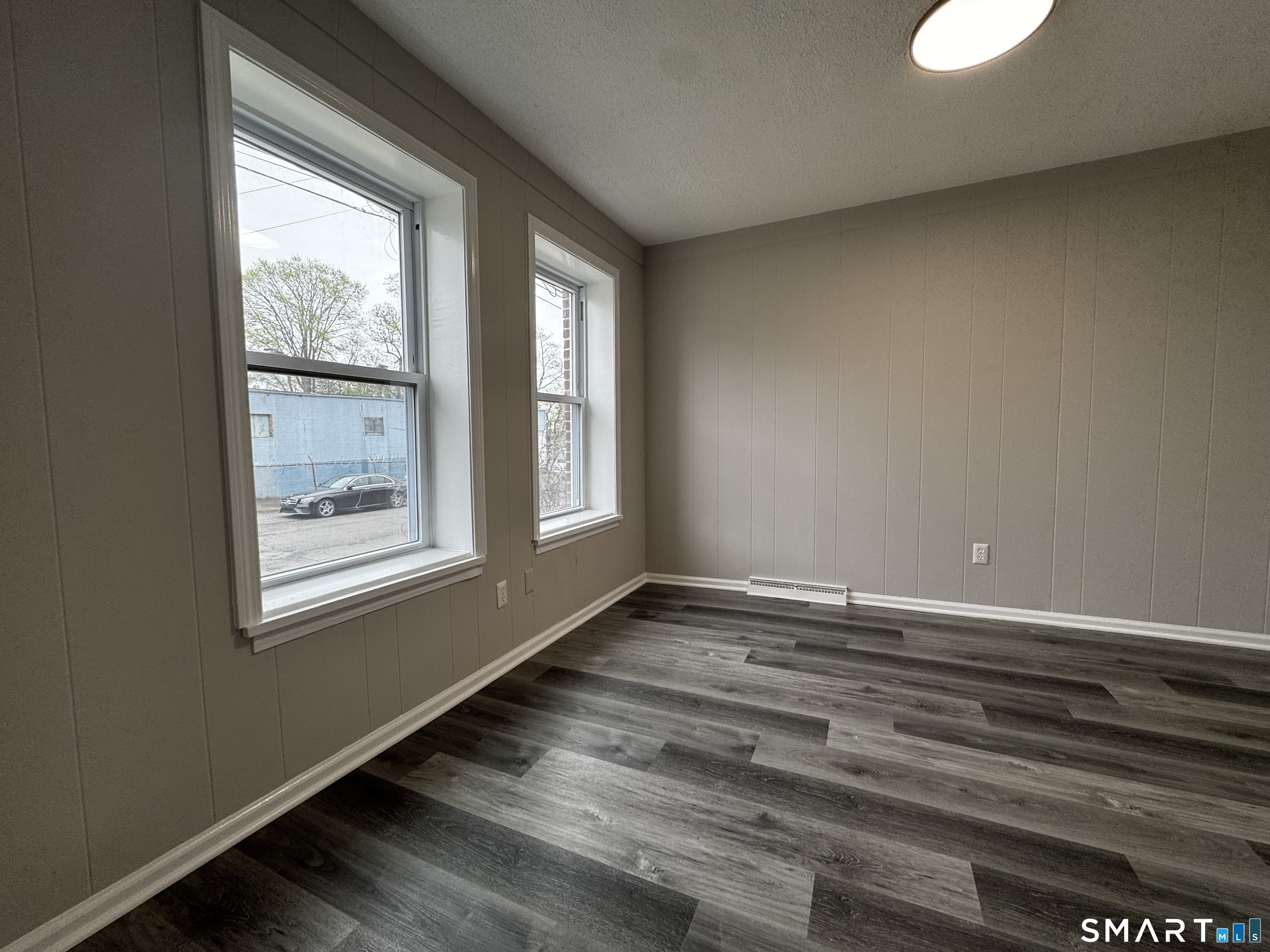 45-51 Cowles Street, Unit 45 Bridgeport, CT 06607 - Photo 24 of 33 a view of an empty room with wooden floor and a window