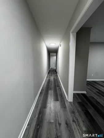 a view of entryway and hall with wooden floor