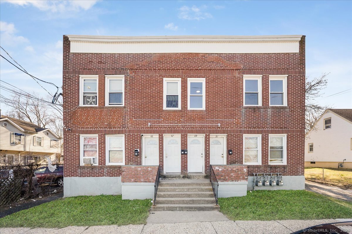 45-51 Cowles Street, Unit 45 Bridgeport, CT 06607 - Photo 29 of 33 a front view of a house with garden and porch