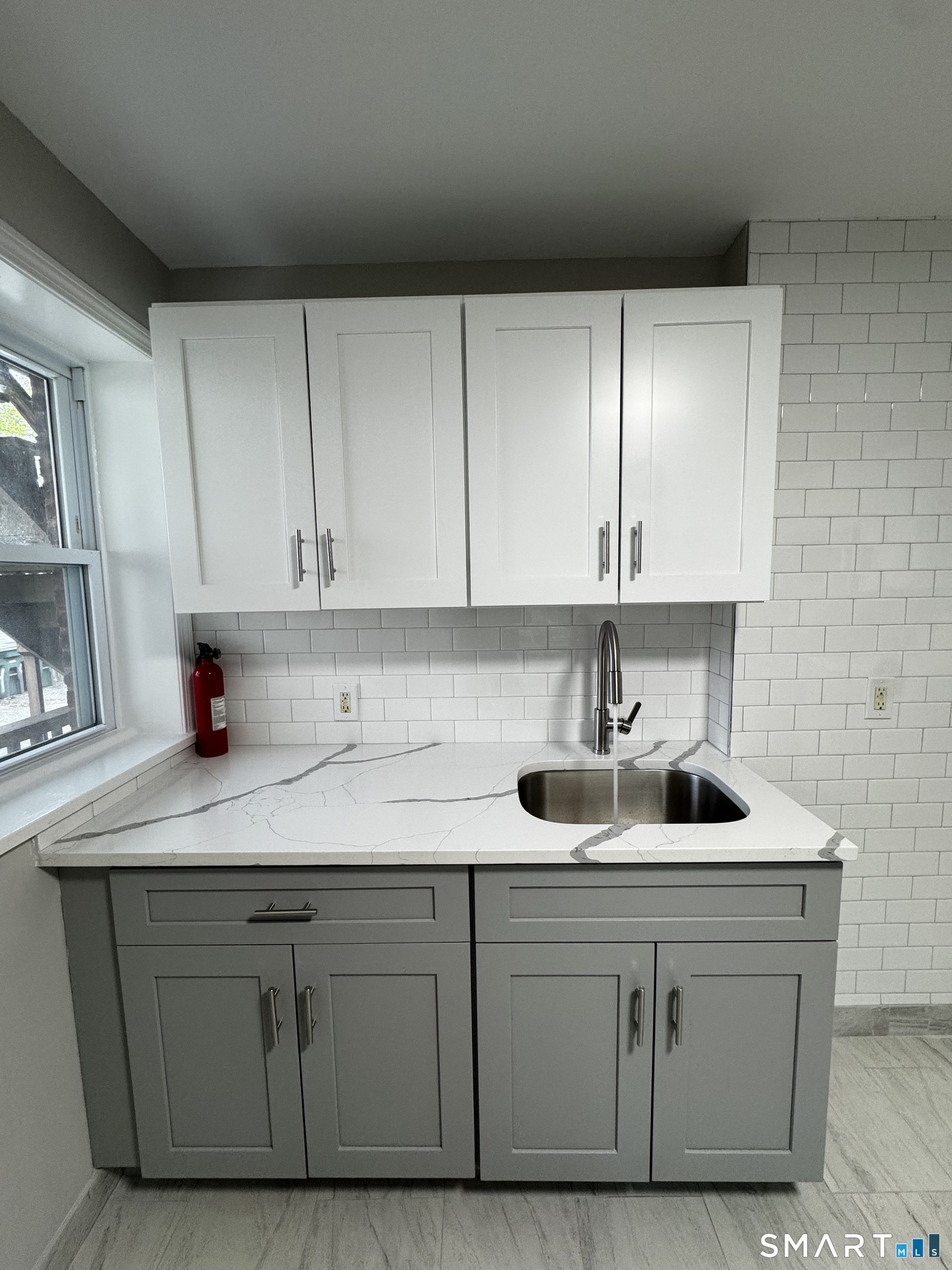 45-51 Cowles Street, Unit 45 Bridgeport, CT 06607 - Photo 4 of 33 a kitchen with white cabinets and sink