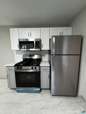 a kitchen with a refrigerator stove and microwave