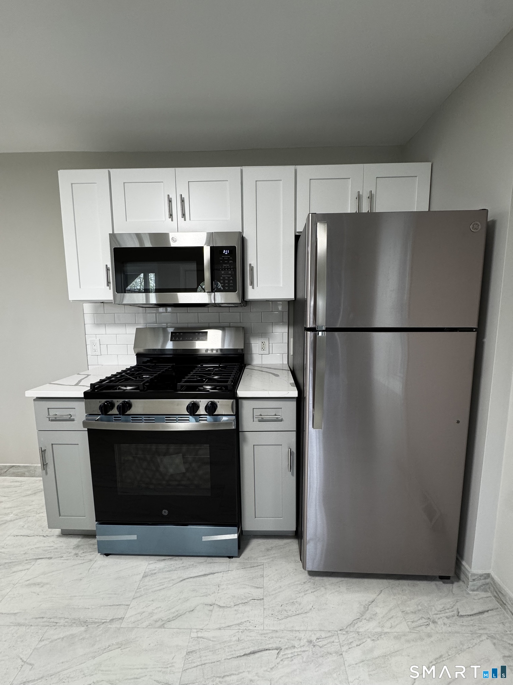 45-51 Cowles Street, Unit 45 Bridgeport, CT 06607 - Photo 7 of 33 a kitchen with a refrigerator stove and microwave