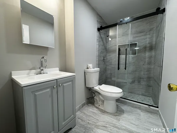 a bathroom with a sink toilet and shower