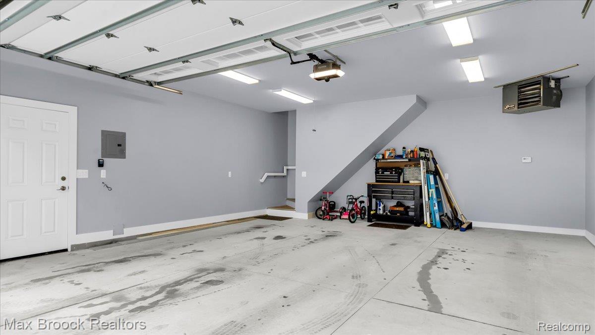 2253 Pembroke Road Birmingham, MI 48009 - Photo 41 of 56 Garage with overhead door, concrete flooring, and ceiling-mounted lighting