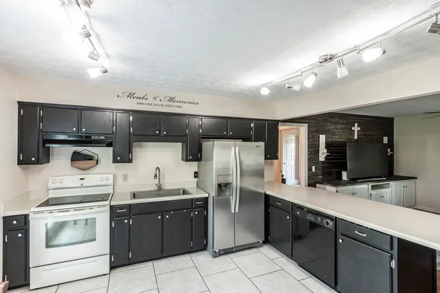 a kitchen with a sink stainless steel appliances and cabinets