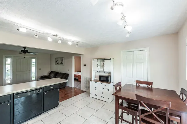 a large kitchen with a table and chairs in it