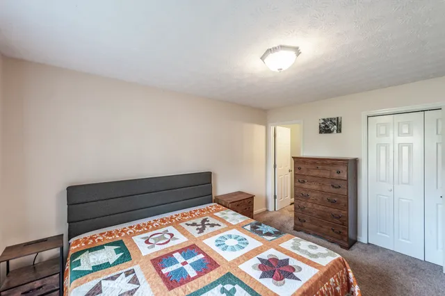 a bedroom with a bed and a dresser