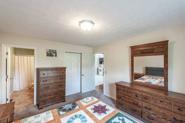 a bed room with a bed and a dresser