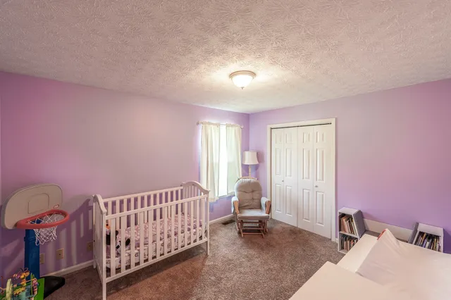 a bedroom with furniture and a window