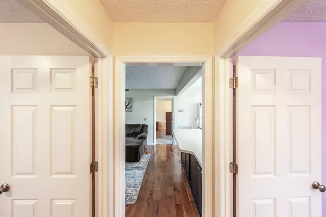 a view of a hallway with a wooden floor