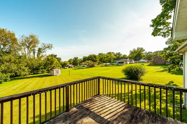 a view of a balcony with wooden floor