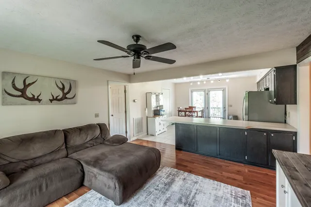 a living room with furniture and a chandelier