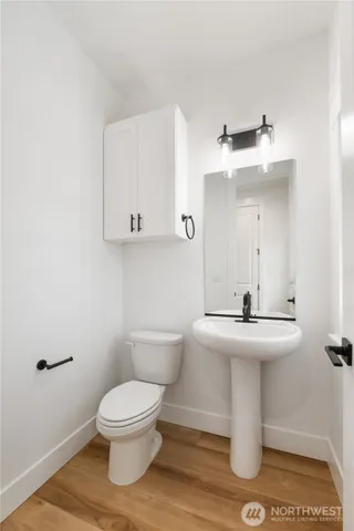 a white toilet sitting next to a bathroom sink