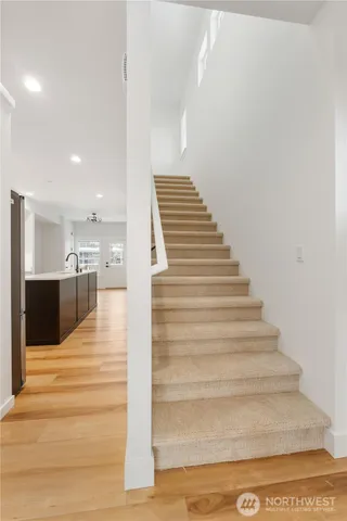 a view of entryway and hall with wooden floor