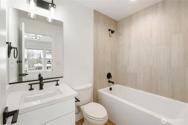 a bathroom with a sink a toilet and a bathtub