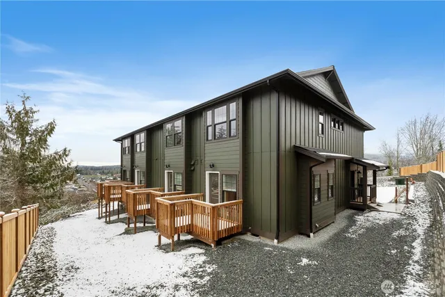 a view of a house with backyard porch and sitting area