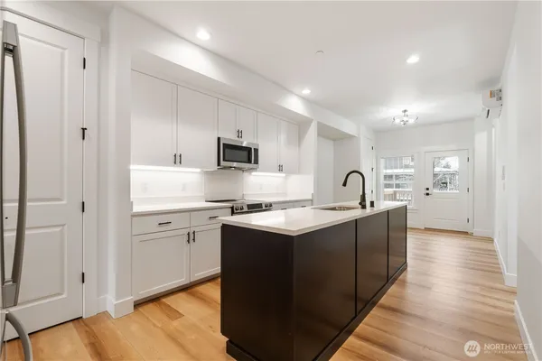 a kitchen with stainless steel appliances granite countertop a sink stove and refrigerator