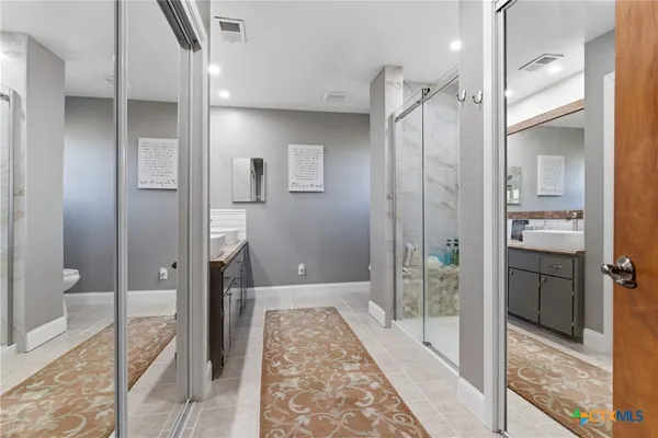 a bathroom with a shower and a glass door