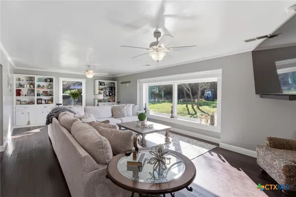 a living room with furniture a fireplace and a table