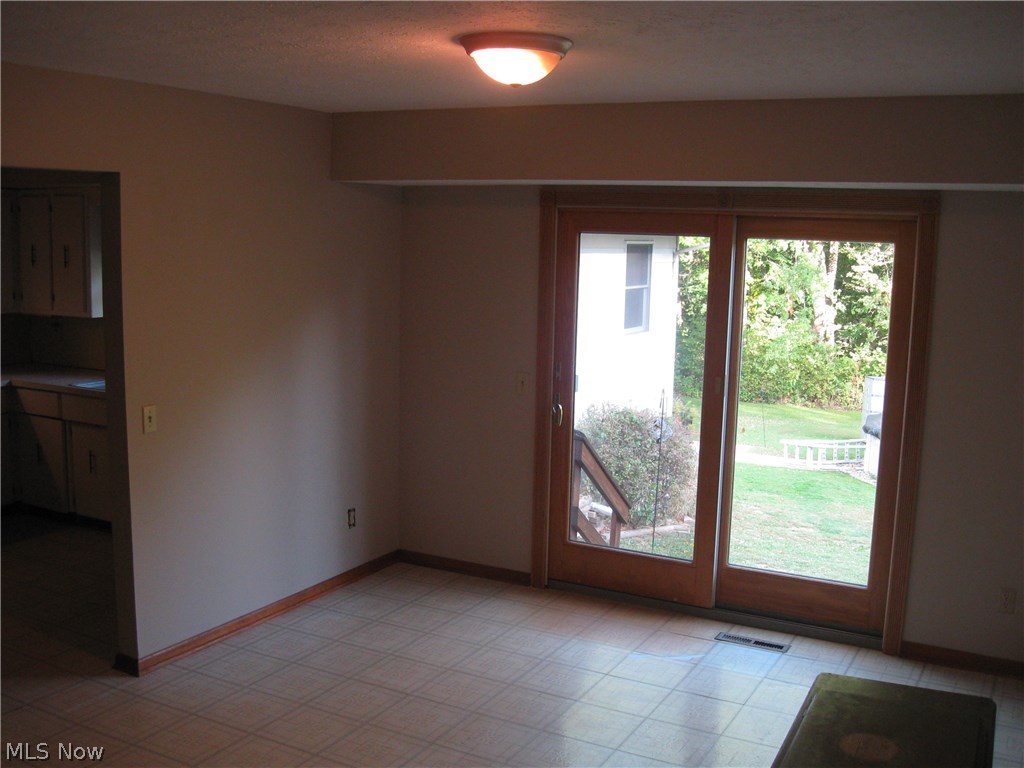 9020 Diagonal Road Streetsboro, OH 44241 - Photo 5 of 26 The dining room features neutral decor, is spacious and features sliding doors to the backyard and pool.