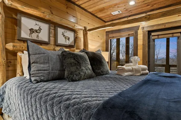 a bedroom with a large bed and a large window