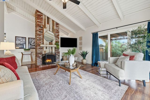 a living room with fireplace furniture and a flat screen tv