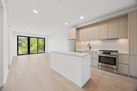 a kitchen with a stove a sink and a refrigerator