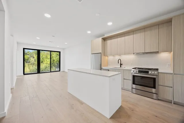 a kitchen with a stove a sink and a refrigerator