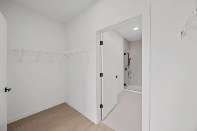 a bathroom with a toilet a sink a mirror and vanity