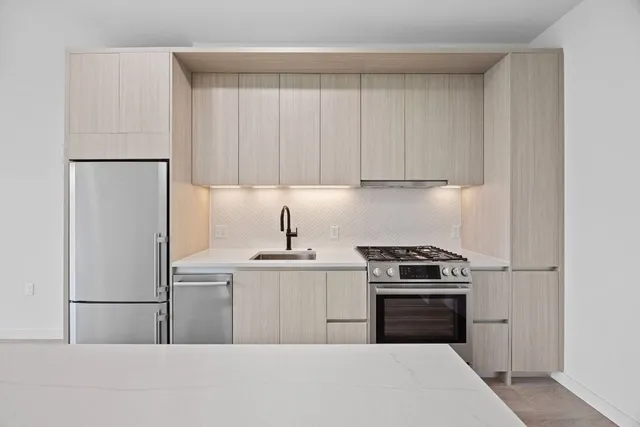 a kitchen with a sink a stove and refrigerator
