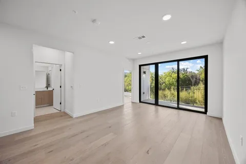 a view of an empty room with wooden floor