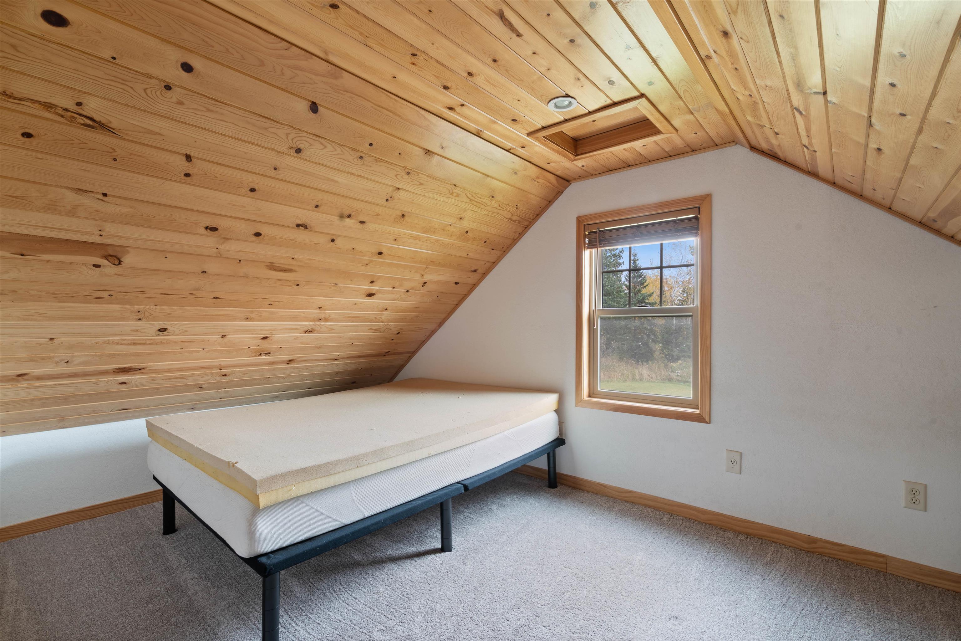 4202 Zachau Road Superior, WI 54880 - Photo 18 of 37 Bedroom with wood ceiling, vaulted ceiling, and light carpet