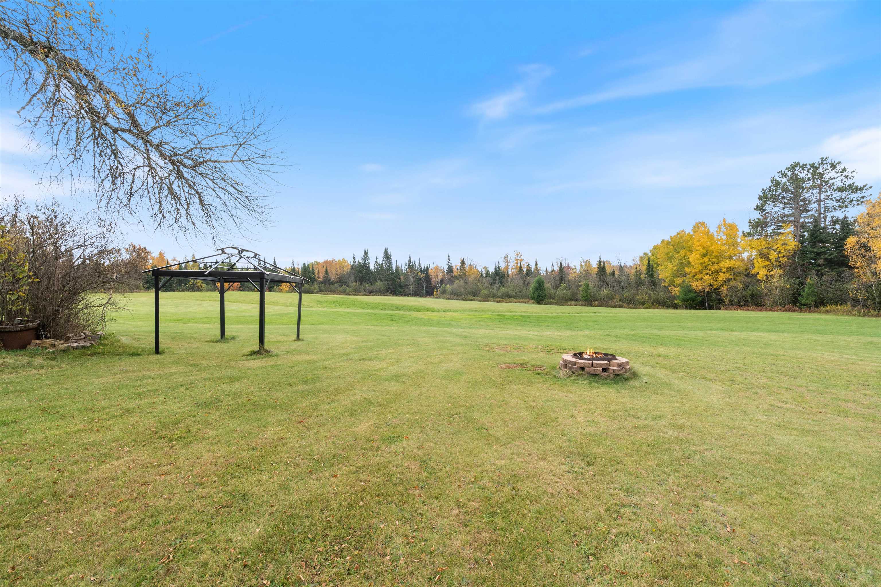 4202 Zachau Road Superior, WI 54880 - Photo 27 of 37 View of green lawn with an outdoor fire pit