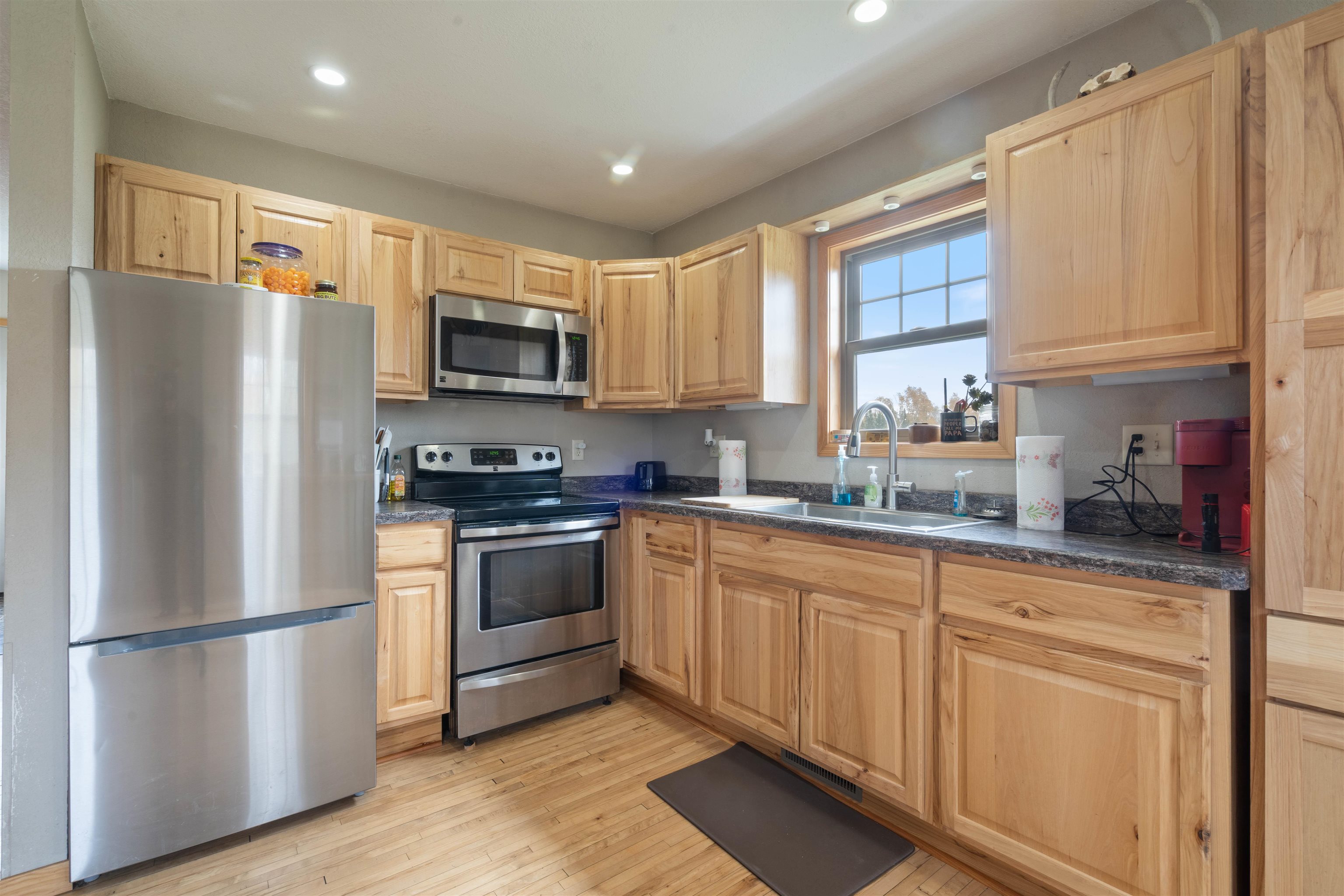 4202 Zachau Road Superior, WI 54880 - Photo 8 of 37 Kitchen featuring stainless steel appliances, dark countertops, light brown cabinets, light wood-type flooring, and recessed lighting