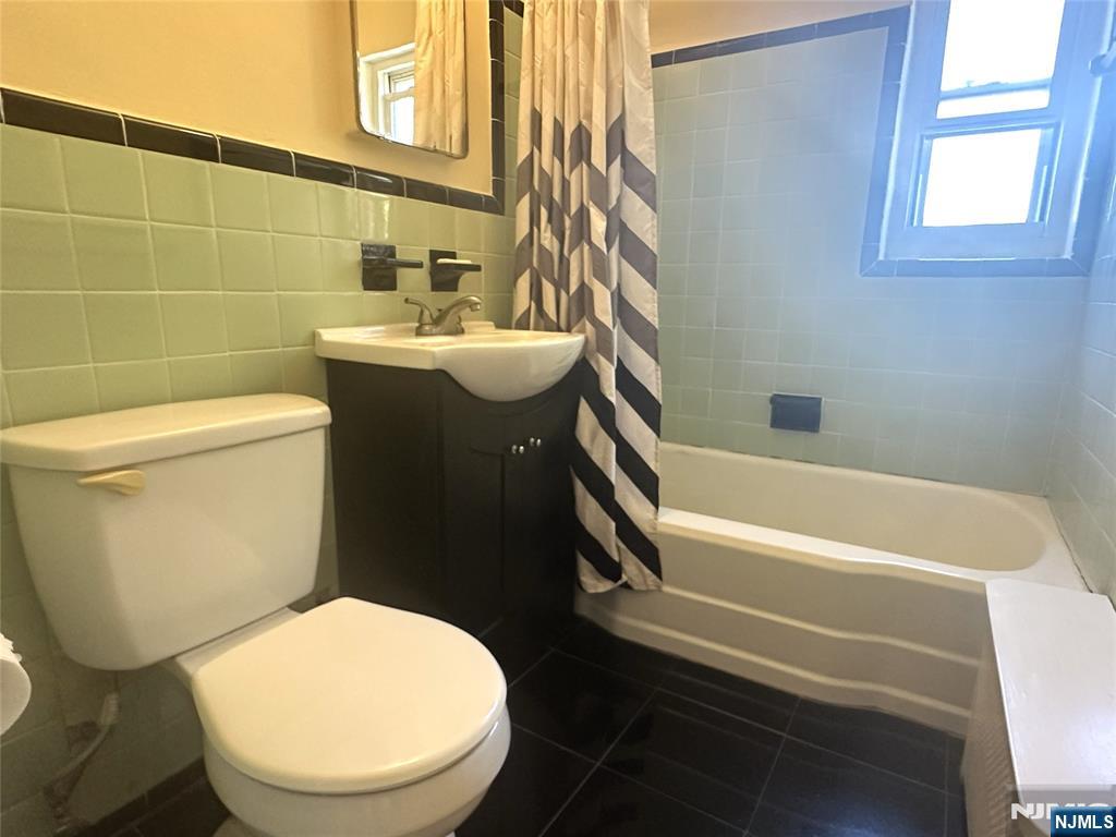 460 Heath Place, Unit 48 Hackensack, NJ 07601 - Photo 9 of 10 a white toilet sitting next to a bathroom sink