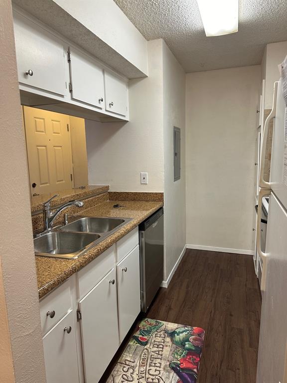 5300 Keller Springs Road, Unit 1090 Dallas, TX 75248 - Photo 2 of 10 Kitchen featuring a sink, dishwasher, white cabinets, dark wood-type flooring, and a textured ceiling