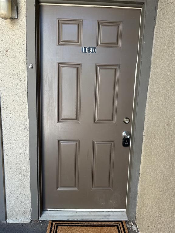 5300 Keller Springs Road, Unit 1090 Dallas, TX 75248 - Photo 9 of 10 Doorway to property featuring stucco siding