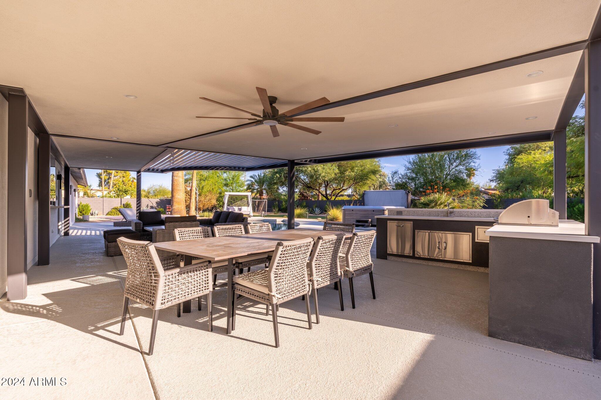 6025 East Charter Oak Road Scottsdale, AZ 85254 - Photo 104 of 115 a view of a patio with a table and chairs