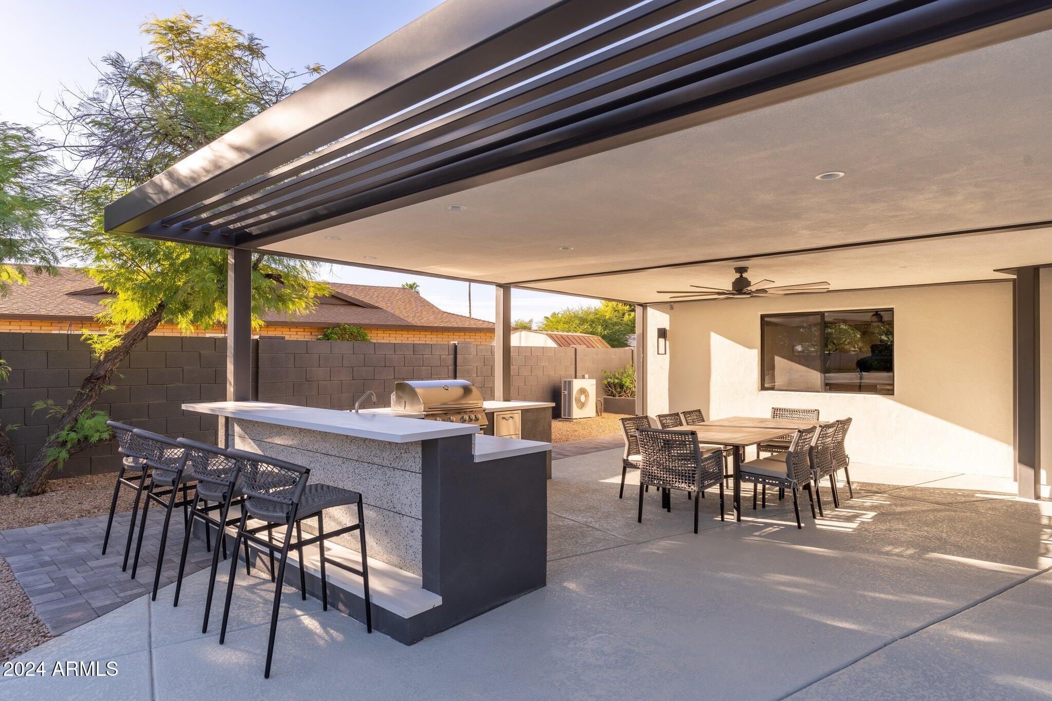 6025 East Charter Oak Road Scottsdale, AZ 85254 - Photo 105 of 115 a view of a patio with a table chairs and backyard