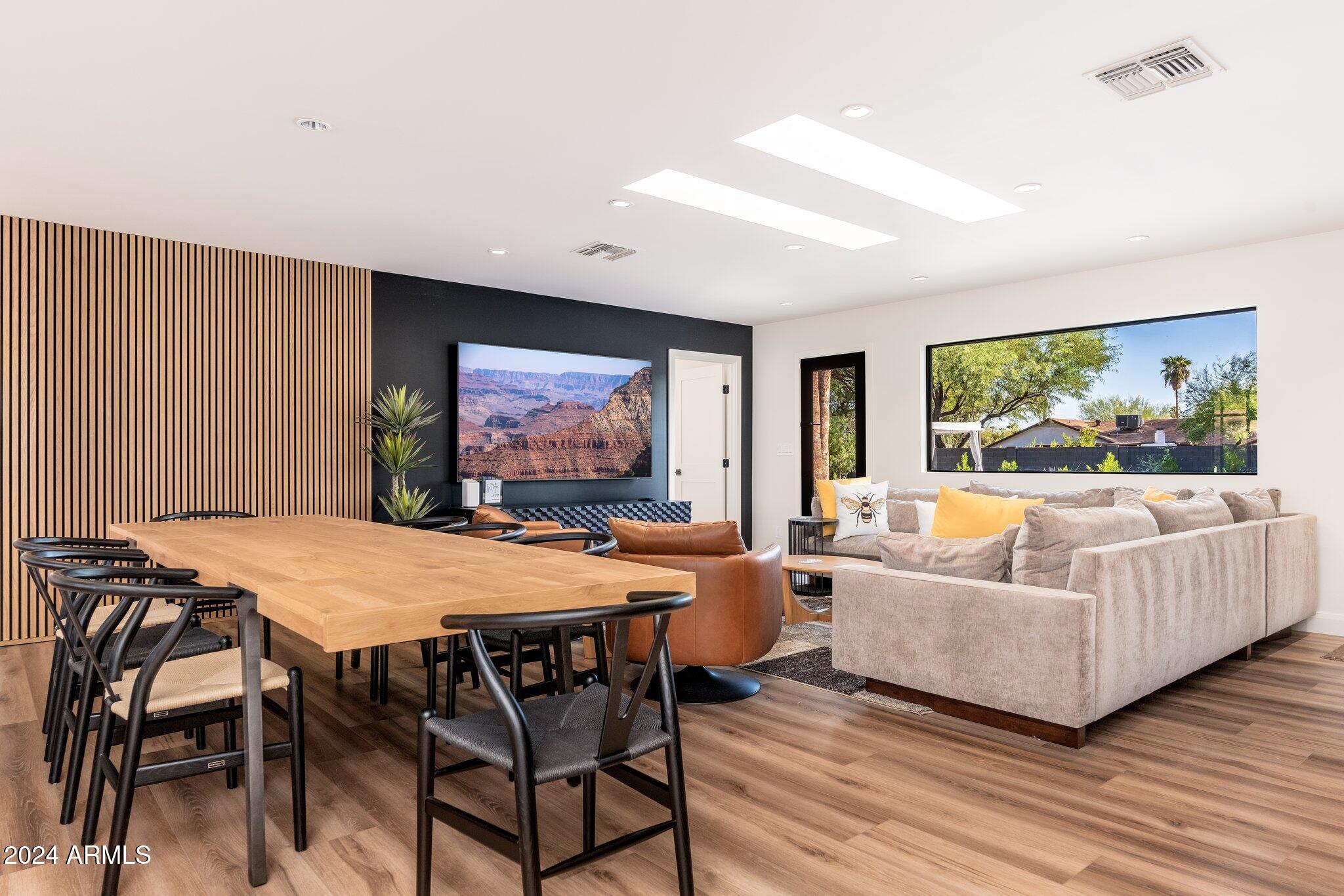 6025 East Charter Oak Road Scottsdale, AZ 85254 - Photo 11 of 115 a living room with furniture a flat screen tv and a large window
