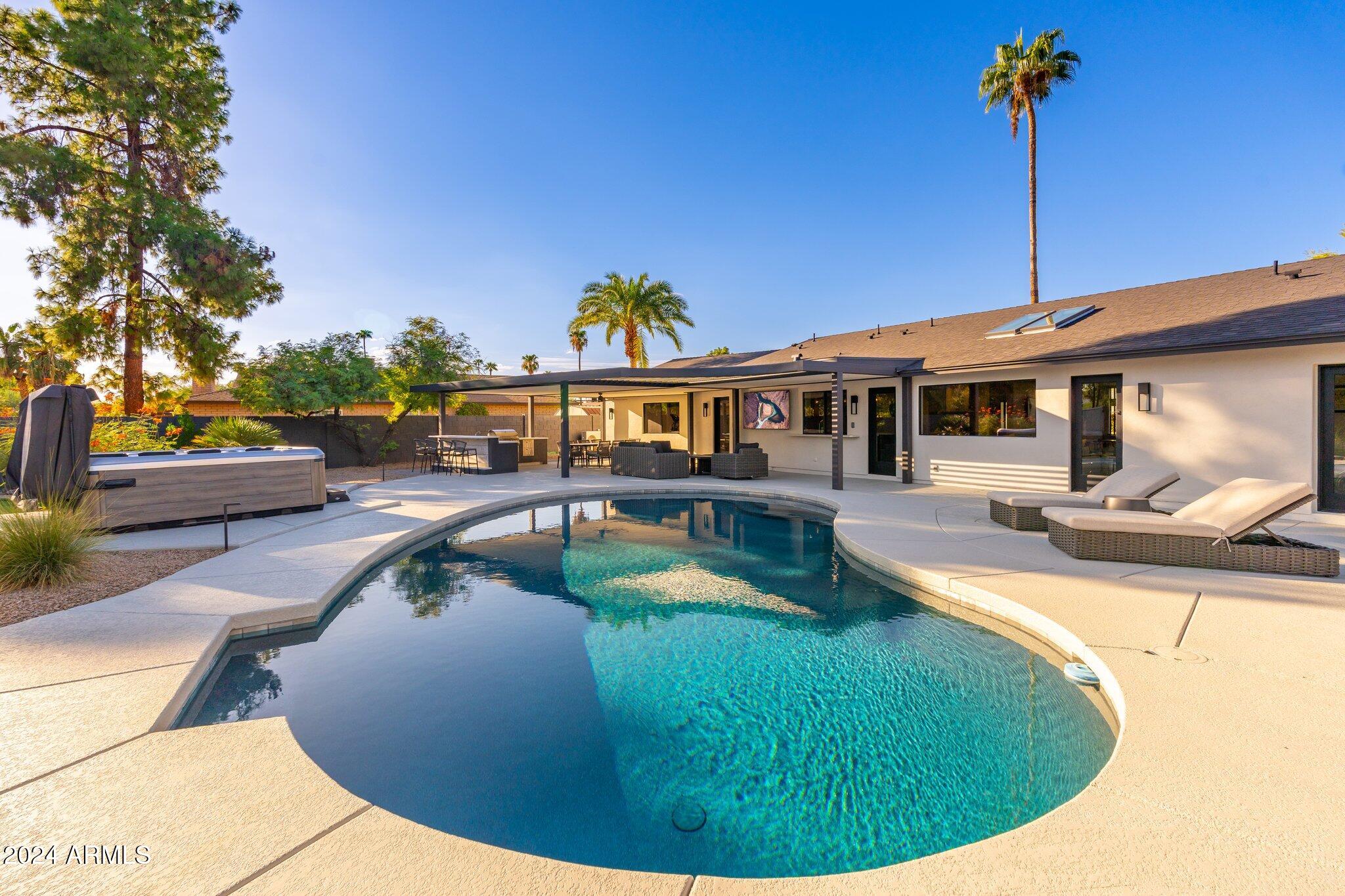 6025 East Charter Oak Road Scottsdale, AZ 85254 - Photo 112 of 115 a view of a house with swimming pool