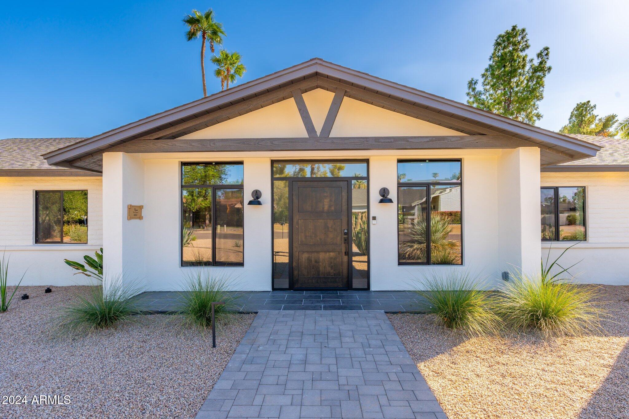 6025 East Charter Oak Road Scottsdale, AZ 85254 - Photo 115 of 115 a front view of a house with garden