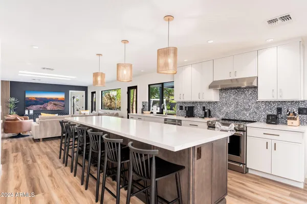 a spacious bedroom with a bed and a chair