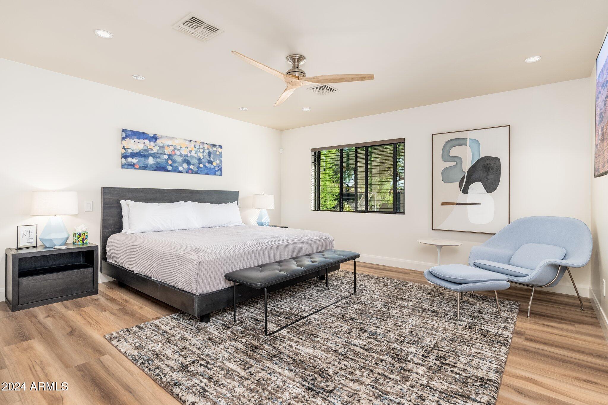 6025 East Charter Oak Road Scottsdale, AZ 85254 - Photo 32 of 115 a bedroom with a large bed and a couch