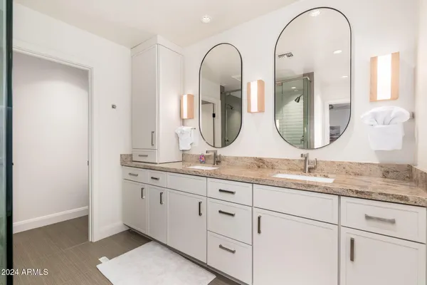 a front view of a house with a garden and trees