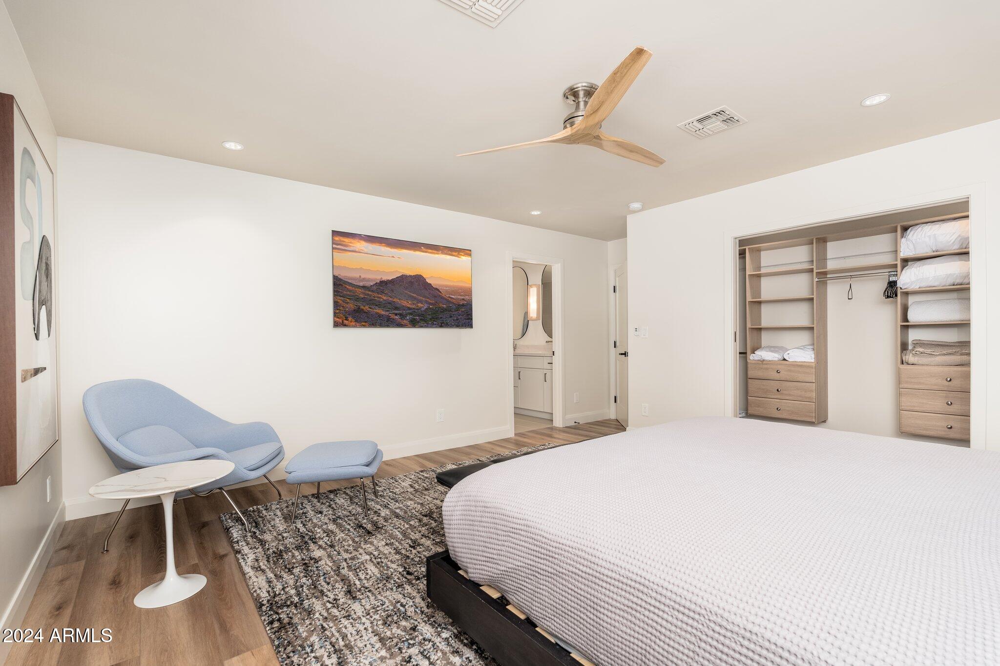 6025 East Charter Oak Road Scottsdale, AZ 85254 - Photo 43 of 115 a spacious bedroom with a bed and a chair